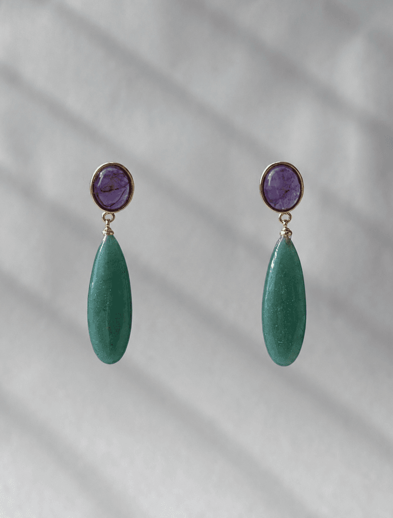 A pair of drop earrings, each a round purple amethyst in a gold bezel above a long smooth green teardrop